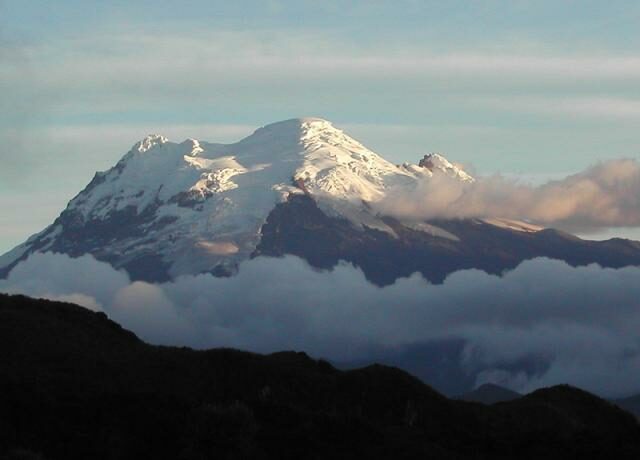 The snow capped peak of Antisana Volcano at sunset.