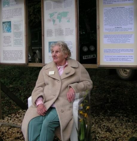 Jane Pointer sitting in front of display boards at Kites Hill.