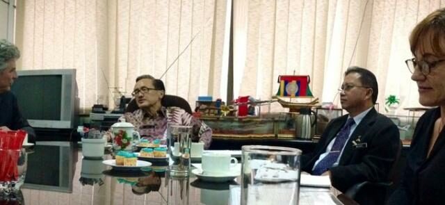 Simon in a meeting with the minister.