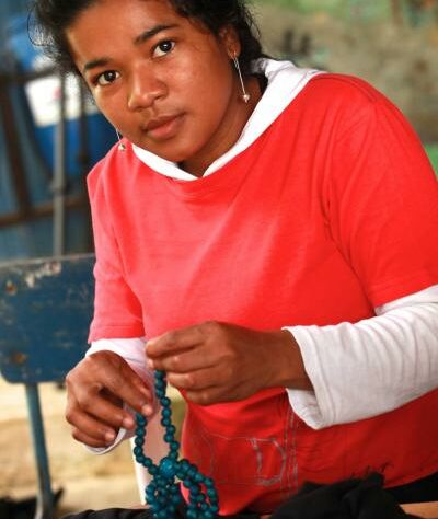 Colombian woman assembling jewellery.