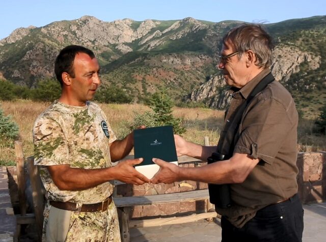 John presenting Gor with binoculars