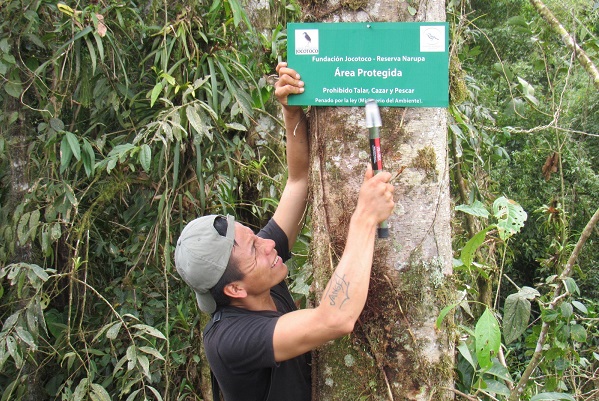 Wildlife ranger putting up protected area sign